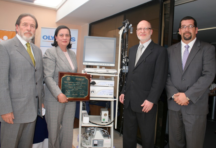 Metrofraternidad Foundation, Quito, Ecuador, 2010: Ceremony for donation of Olympus tower and endoscopes. Dr Luis Rodrigo Vineza Rojas, Medical Director (left), Dr James DiSario from WEO (3rd from left), Olympus Latin America representative far right, and Metrofraternidad Foundation Executive (2nd from left) at the at the Opening Ceremony of the Fundación Metrofraternidad Outreach Center in Quito, Ecuador, 2004.